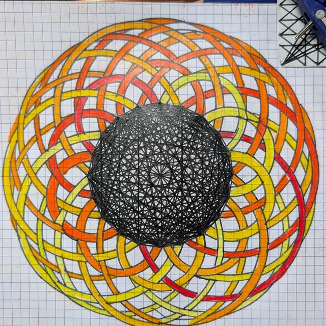 Coloured-pencil drawing on grid paper of many yellow, orange and red rings woven over and under each other into a torus, around a dark stippled sphere in the middle.