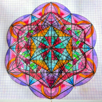 Hand-drawn geometric figure on grid paper: Metatron's Cube, with straight black lines forming a six-pointed star, coloured in pink, purple, orange, turquoise and green inside six rounded petals.